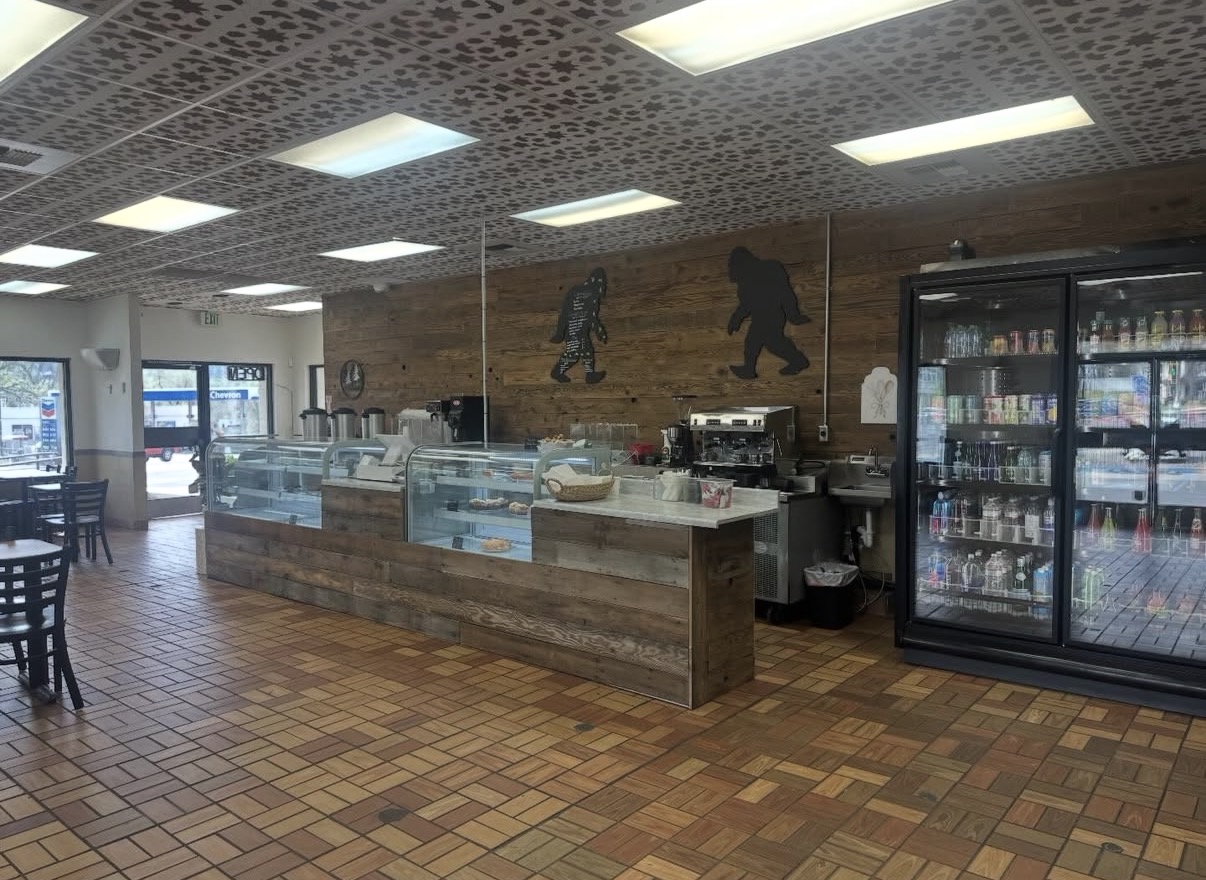 Inside Bigfoot Bakery & Grill, featuring reclaimed-wood counters and bakery display cases
